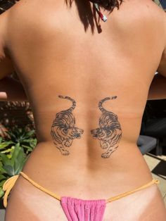 the back of a woman with tattoos on her stomach and side view of a tiger