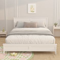 a white bed sitting on top of a wooden floor