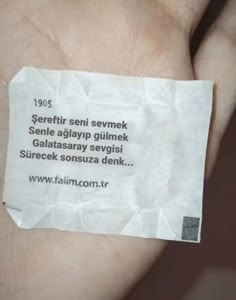 a person's hand holding a piece of paper with the words serefir seymok