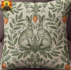 a pillow with two rabbits sitting on top of it