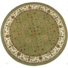 a green and white rug with floral designs on the center, in an oval shape