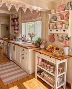 a kitchen filled with lots of pink and white decor