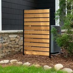 an air conditioner in front of a house with wood slats on the side