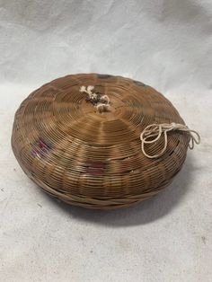 a wicker basket sitting on top of a white cloth