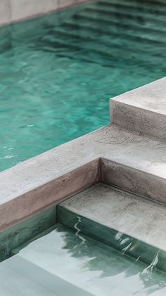 an empty swimming pool with steps leading up to it