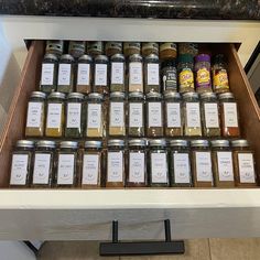 an open drawer filled with lots of spices