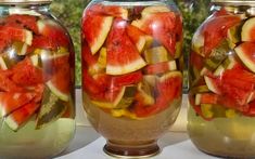 three jars filled with pickles and watermelon slices