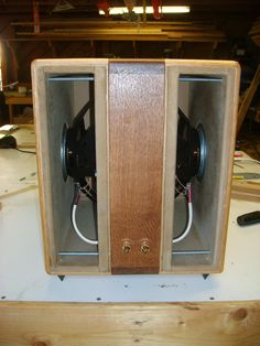 two speakers sitting inside of a wooden box