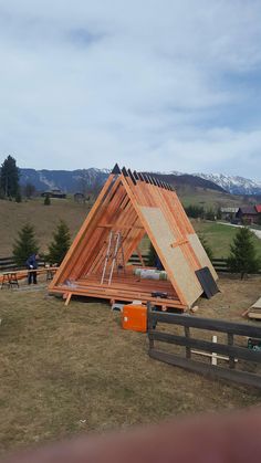 a wooden structure with some people standing around it