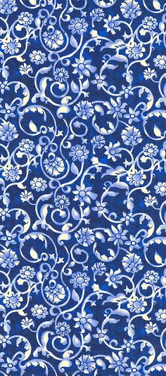 a blue and white background with swirls and flowers on it's surface,