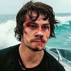 a man with blood all over his face on a boat