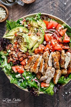 a salad with chicken, tomatoes, avocado and feta cheese