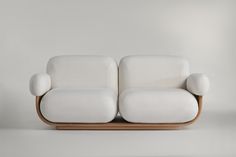 a white couch sitting on top of a wooden frame