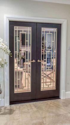 an entry door with decorative glass panels on the front and side doors to both sides