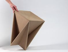 an origami box being held by someone's hand on a white background