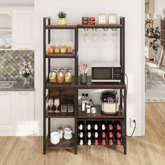 a kitchen with white walls and wooden flooring is shown in this image, there are several shelves on the wall