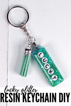 a green keychain with the words lucky written on it and two keys attached to it