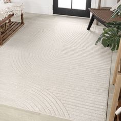 a large white rug in a living room