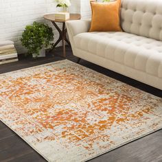 an orange and white rug in a living room