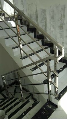 a set of stairs with metal handrails in an empty room