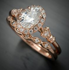 an engagement ring with a large white diamond in the center and two smaller diamonds on each side