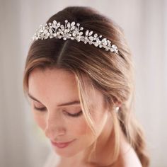 a woman wearing a bridal headpiece in her hair