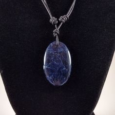 The Sodalite cabochon pendant is approximately 1.6 inches in length and 1.0 inch in width on natural polished round leather. The necklace is adjustable from 16 inches to 32 inches by sliding the knots. Sodalite is a rich royal blue tectosilicate mineral widely used as an ornamental gemstone. Although massive sodalite samples are opaque, crystals are usually transparent to translucent. Sodalite is a member of the sodalite group with hauyne, nosean, lazurite and tugtupite. First discovered by Euro Round Leather, Cabochon Pendant, Leather Necklace, Necklace Handmade, Handmade Necklaces, Ontario, Jewelry Necklace Pendant, Jewelry Design, Jewelry Necklaces