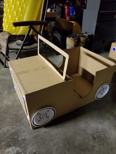 a cardboard car made to look like it's in the process of being built