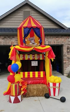 an inflatable circus tent with balloons and decorations