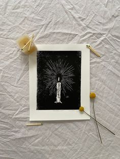 an image of a woman holding a starburst in her hand on top of a sheet of paper