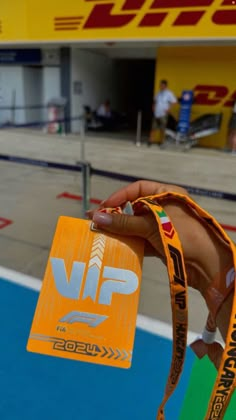 a person holding up a yellow ribbon in front of a store