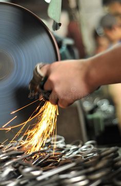 a person is working with metal in a factory royalty images, stock photos and clippings