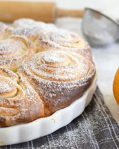 an orange and cinnamon roll sitting on top of a table