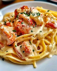 pasta with shrimp, cheese and parmesan sauce on a white plate