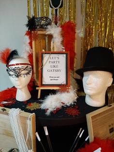 there are many hats and masks on the table with pearls, feathers, and beads