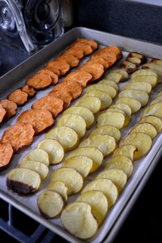 several trays of food sitting on top of a stove