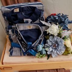 three pieces of cloth and flowers sit on a table next to a basket with two purses