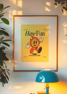 a yellow poster hangs on the wall above a blue table lamp and a green potted plant