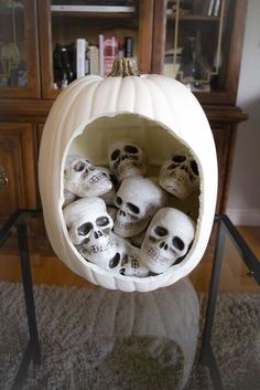 a bunch of skulls in a white pumpkin