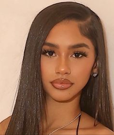 an image of a woman with long hair and brown eyeshadow posing for the camera