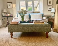 a living room with a couch, coffee table and lamp on the side walk way