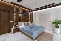 a bedroom with a bed, dressers and plants in the corner on the wall