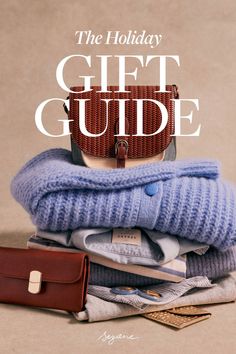 the holiday gift guide is on top of folded sweaters and wallet, with text overlay