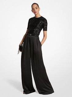 A masterclass in everyday sophistication, these palazzo pants are finely tailored in Italy from liquid-like satin and dyed in a versatile noir hue. The mid-rise silhouette features finely pressed creases that lend effortless movement with each step. Further accentuate the dramatic wide-leg cut with soaring high-heel sandals. Cocktail Outfit Pants Women, Palazzo Pants Cocktail Outfit, Prom Pants Outfits, Wide Leg Pants Outfit Party, Black Pants And Black Top Outfit, Classical Concert Outfit Classy, Glam Black Outfit, Prom Outfits Pants, Formal Pants Outfit Wedding