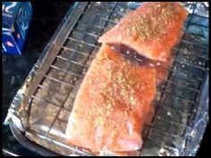 a piece of fish is being cooked on a grill