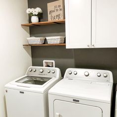 a white washer and dryer sitting next to each other in a laundry room