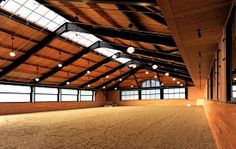 an empty horse barn with lots of windows