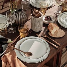 the table is set with dishes and utensils