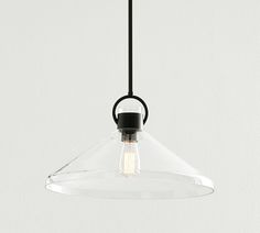 a clear glass light fixture hanging from a black metal ceiling lamp with an acrylic bulb