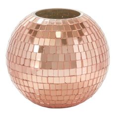 a shiny pink vase is sitting on a white surface and it looks like the inside of a disco ball